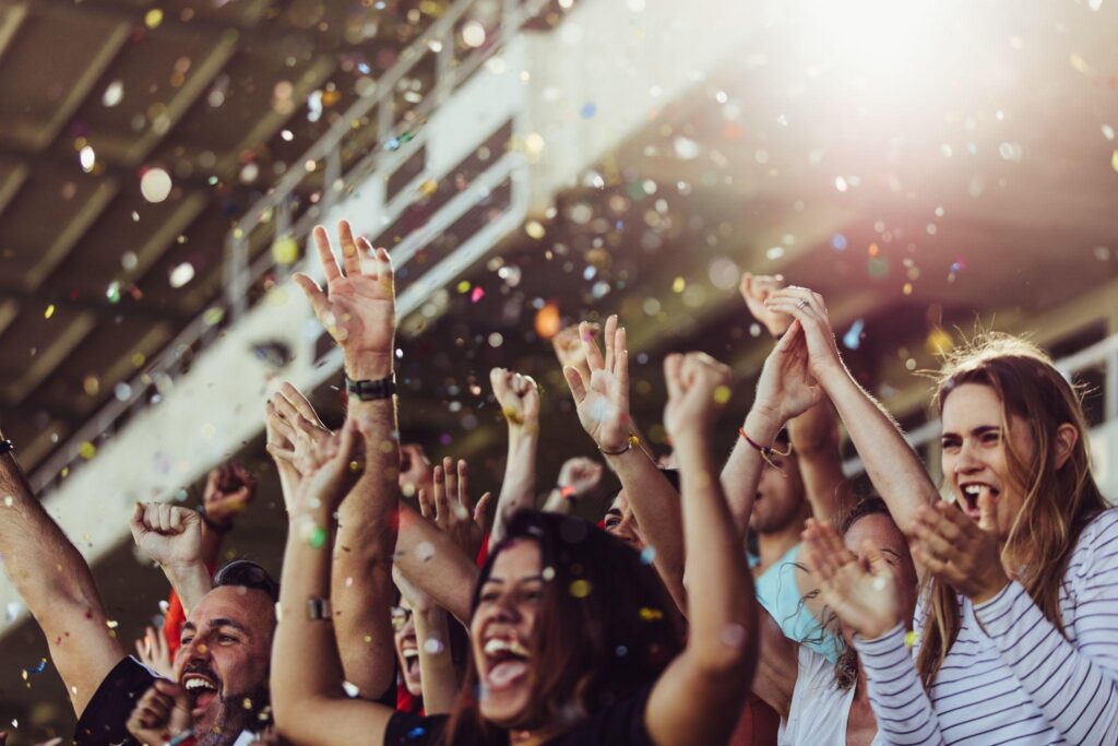 Fans celebrating at a stadium with a reverse ATM