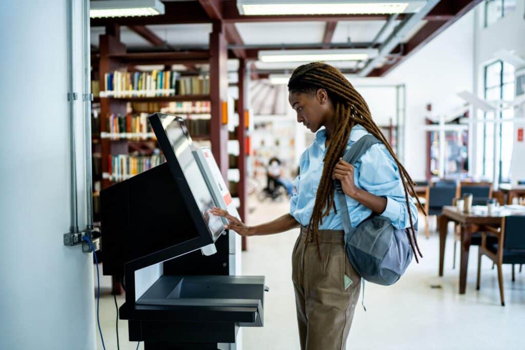 Woman using a reverse ATM in a library
