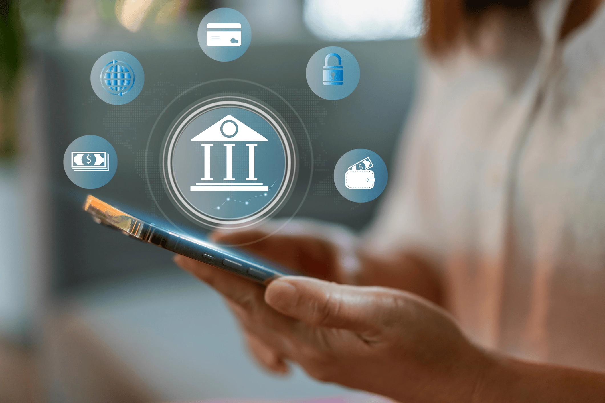 A person holds a smartphone, with digital banking icons such as a bank, credit card, lock, wallet, and money displayed above the device, representing online banking and financial technology.
